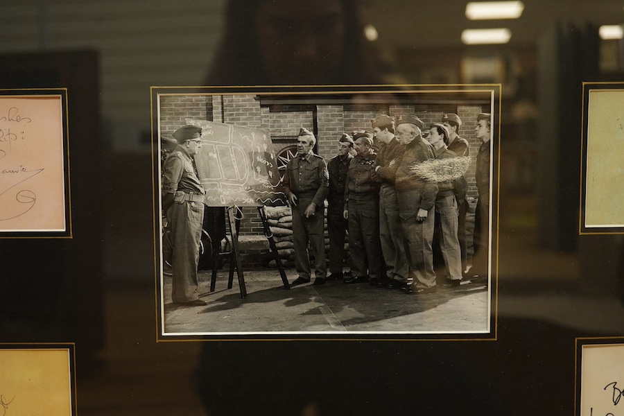 A framed and mounted display of ten autographs from the cast of Dad's Army, together with two photographs, signatures include